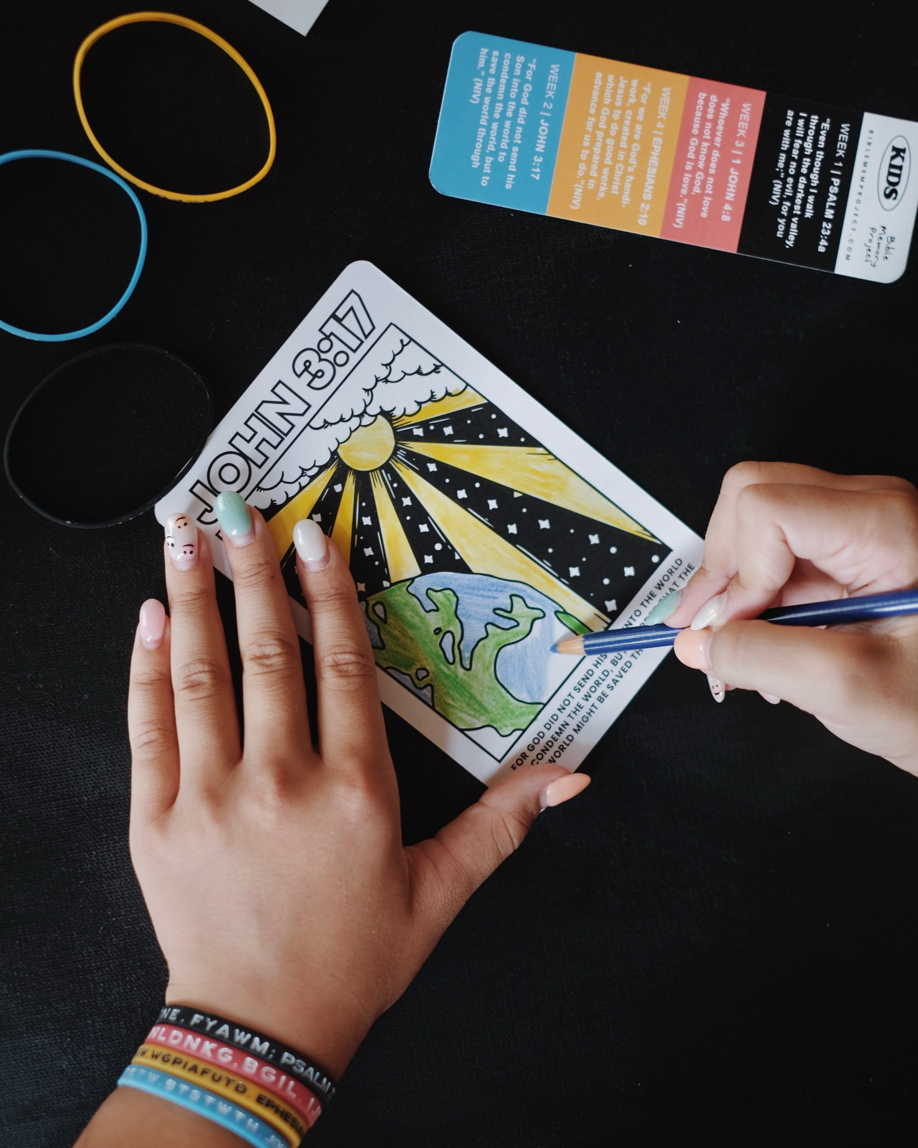 Person coloring a Bible Memory Project coloring page