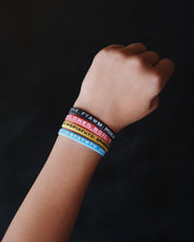 Four Bible Memory Project wristbands on a wrist