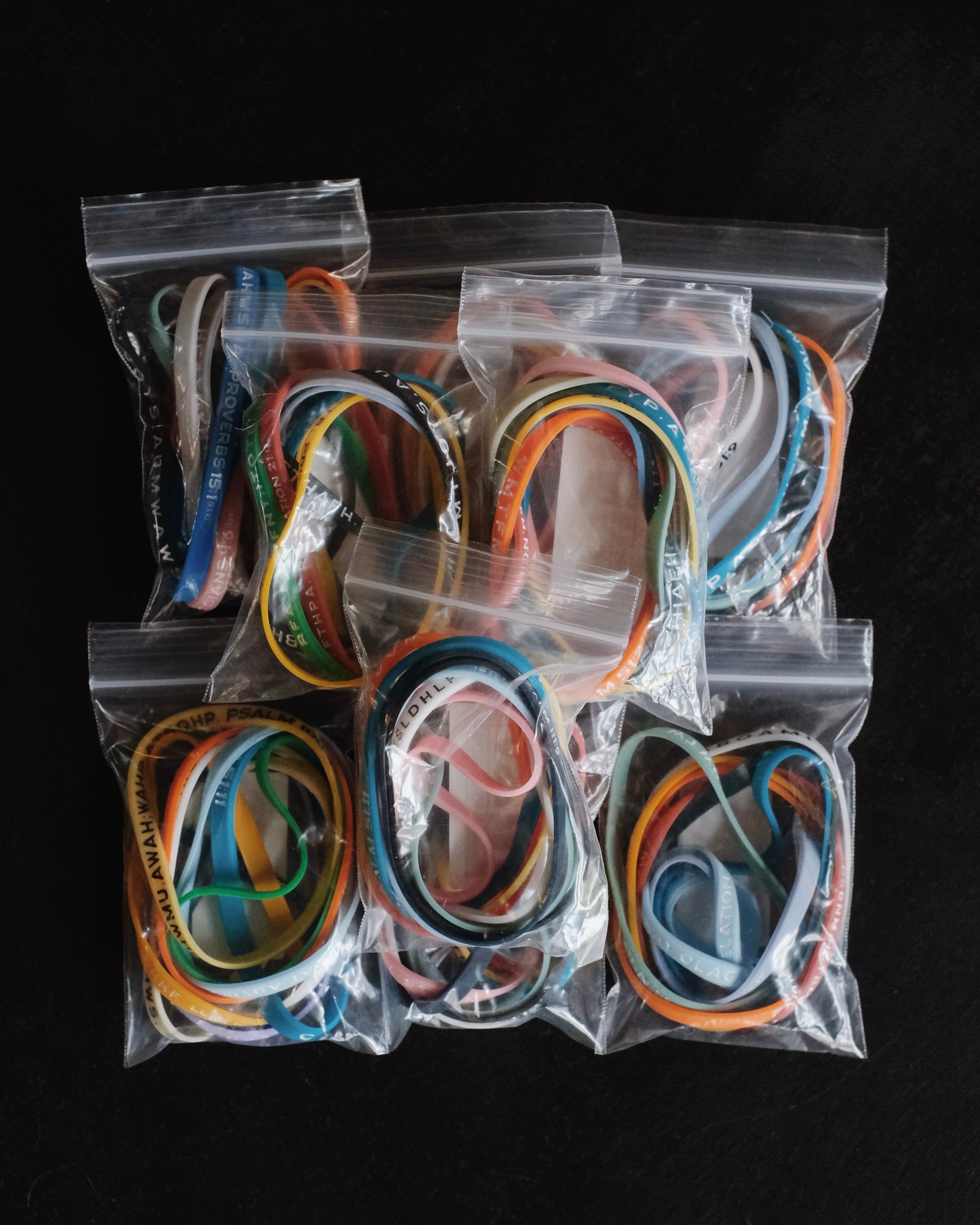 Nine packages with assorted Bible Memory Project wristbands