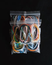 Seven packages with assorted Bible Memory Project wristbands