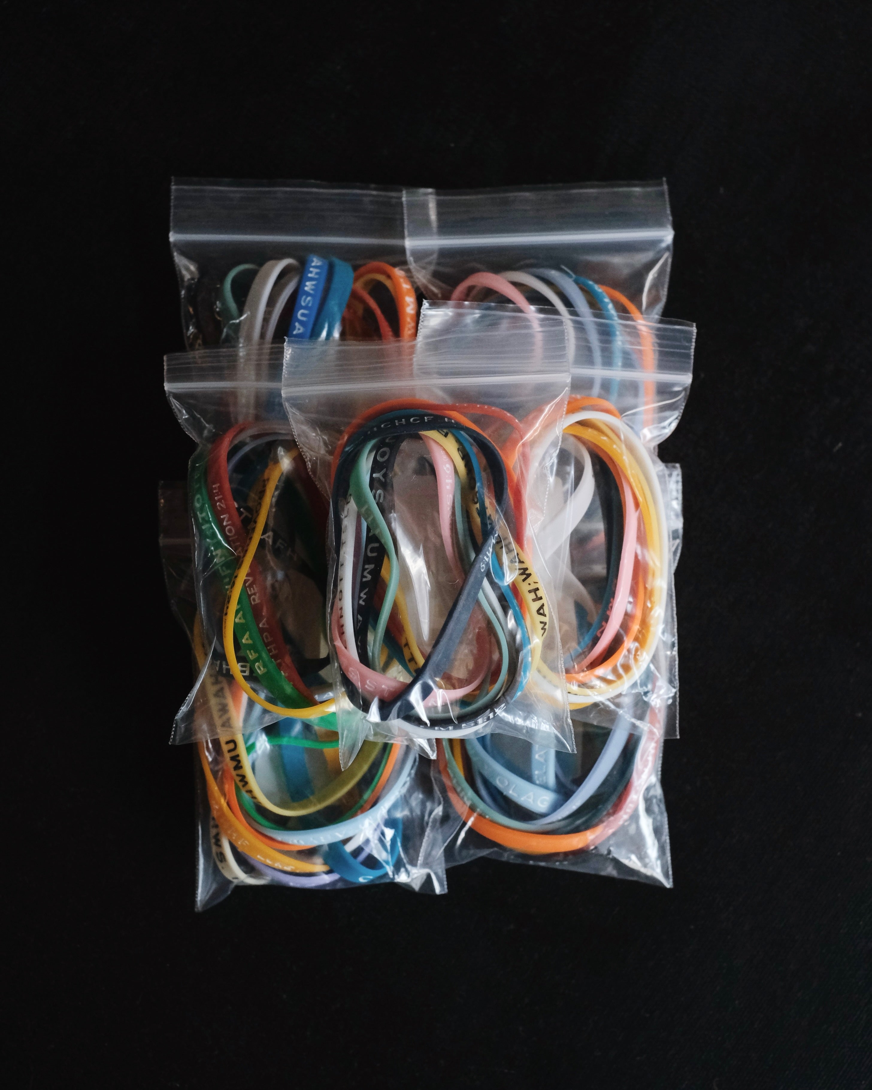 Seven packages with assorted Bible Memory Project wristbands