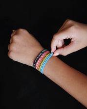 Four Bible Memory Project wristbands on a wrist