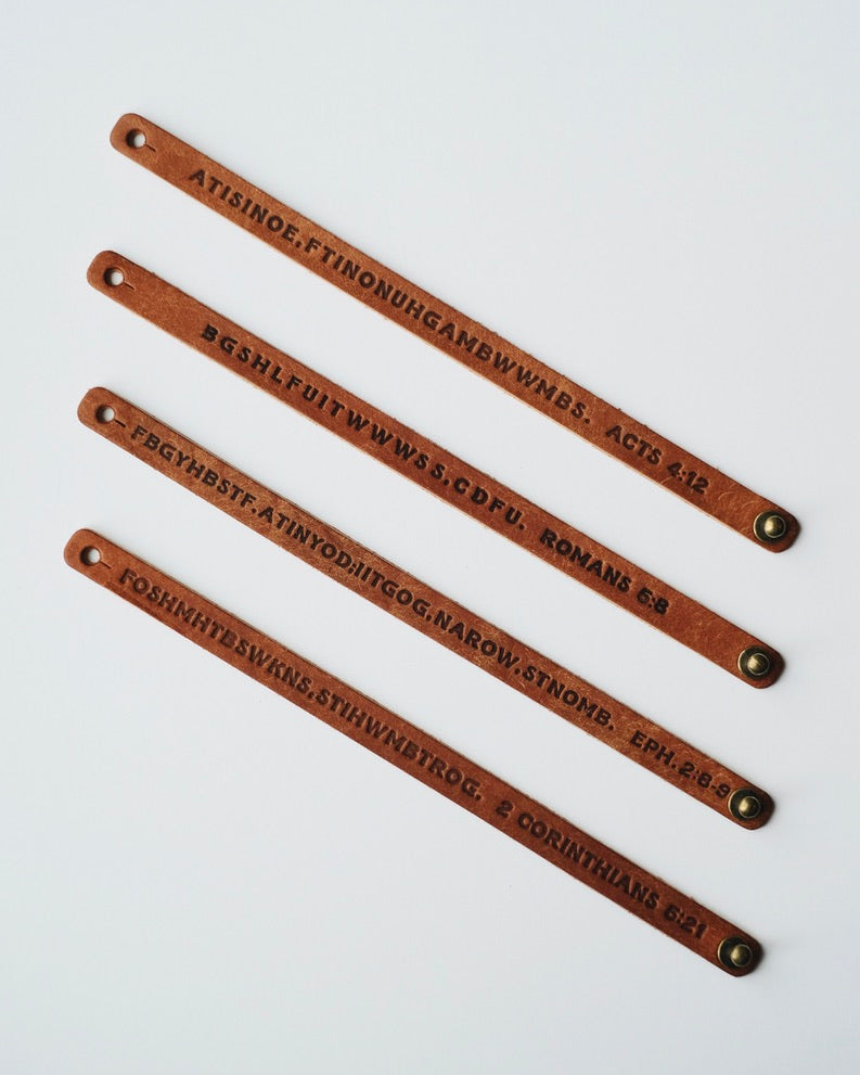 Four dark leather wristbands