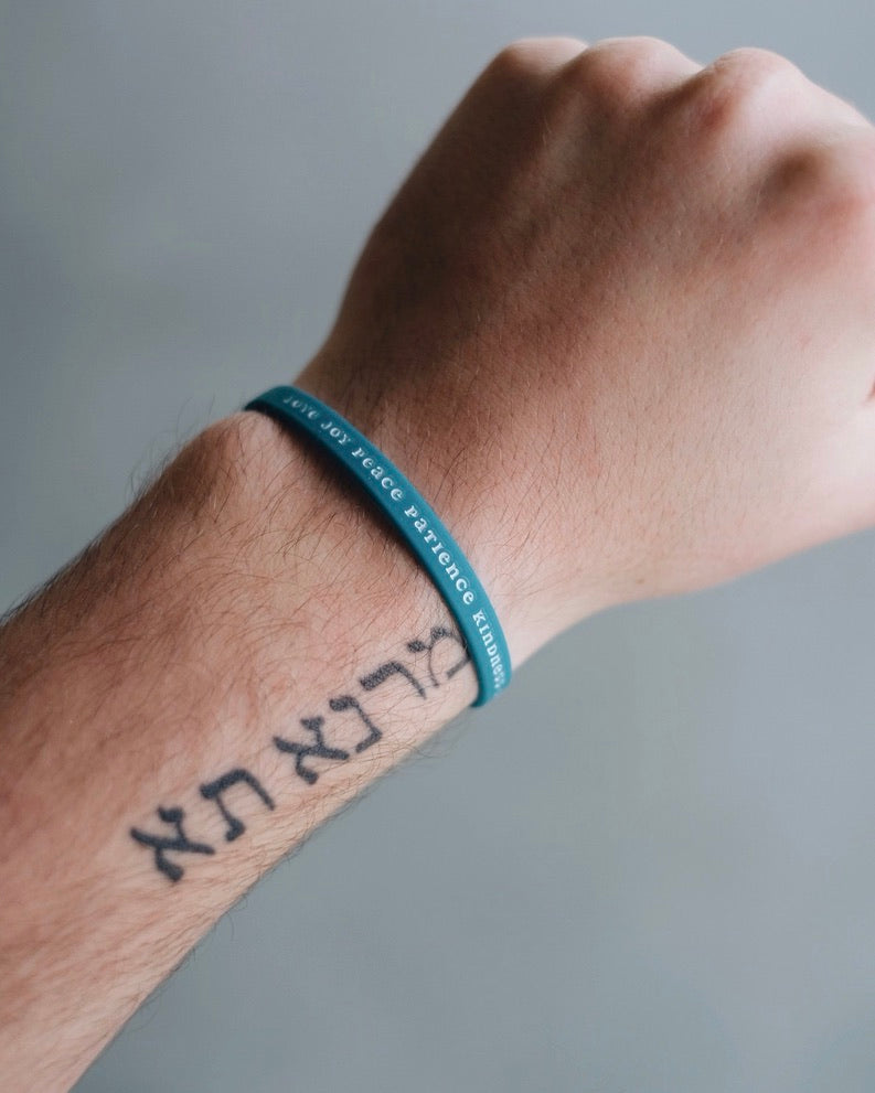 Blue Bible Memory Project wristband on a wrist