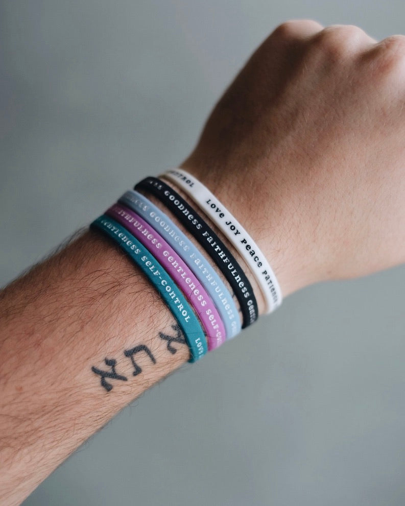 Five Bible Memory Project wristbands on a wrist